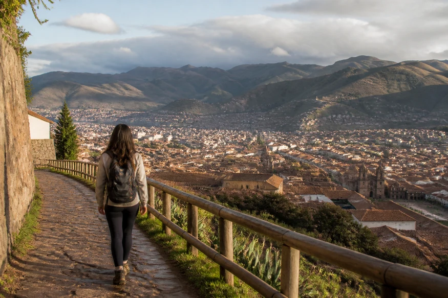 Traveler acclimatizing with a gentle walk overlooking Cusco