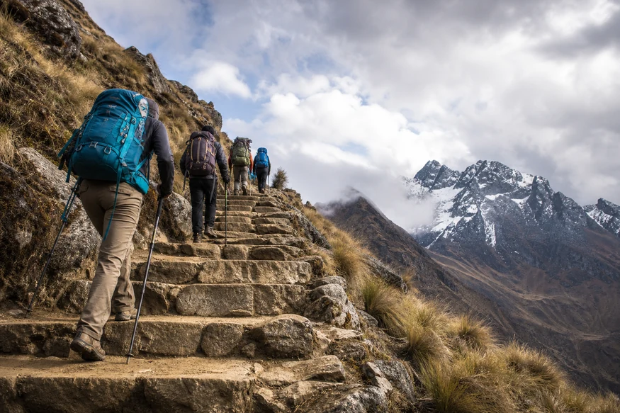 Hikers climbing the long stone ascent toward Dead Woman's Pass on the Inca Trail