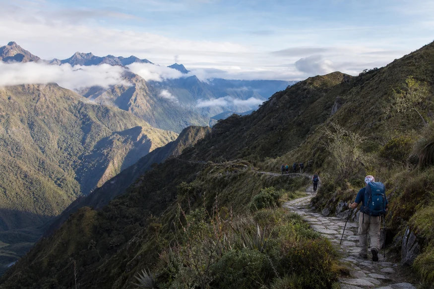 Hikers following a long stone section of the Classic Inca Trail through the Andes
